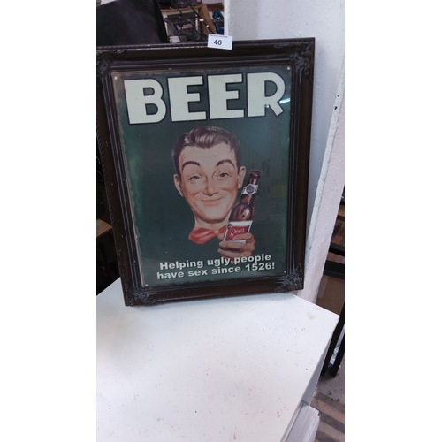 40 - Vintage-style beer advertisement in an ornate wooden frame. Features a humorous mid-century design w... 