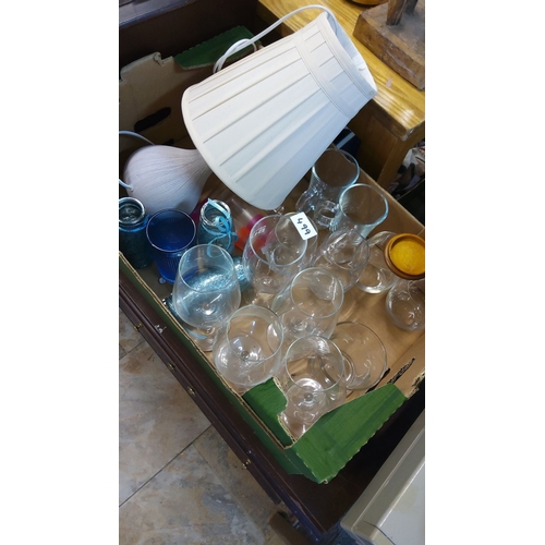 499 - Mixed lot featuring assorted stemware, glassware, decorative jars, and a table lamp with shade.