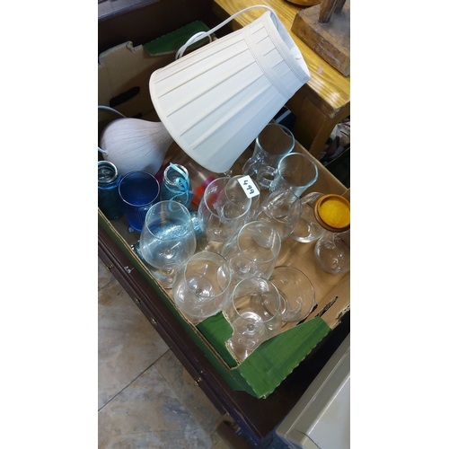 499 - Mixed lot featuring assorted stemware, glassware, decorative jars, and a table lamp with shade.