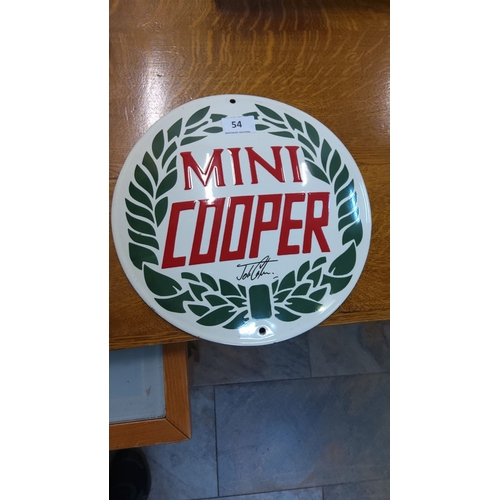 54 - Mini Cooper enamel sign features an iconic red and green design with a laurel wreath. The sign is pr... 