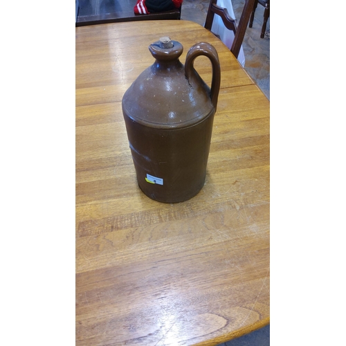 8 - Antique Brown Glazed Stoneware Jug, Early 20th Century. Features a single handle and cork stopper.