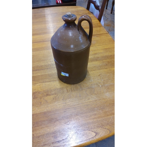 8 - Antique Brown Glazed Stoneware Jug, Early 20th Century. Features a single handle and cork stopper.