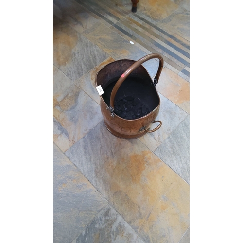 114 - Antique Copper Coal Scuttle from the 19th century features a hammered copper body with original swin... 