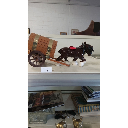 2 - Ceramic horse figurine pulls a wooden cart with brass accents.