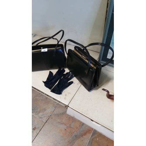 28 - Pair of classic black vintage handbags with gold-tone accents, accompanied by elegant navy gloves.