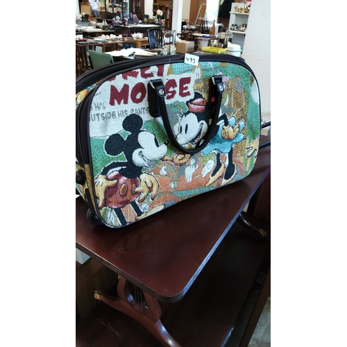 473 - Vintage-style tapestry rolling travel bag features classic Mickey and Minnie Mouse comic design. It ... 