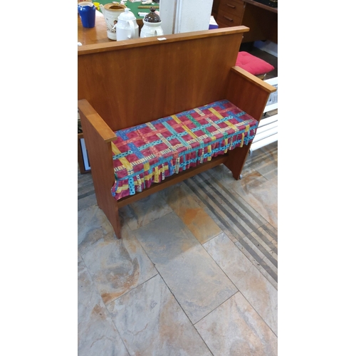 64 - Mid-century wooden bench with colorful fabric seat cover.