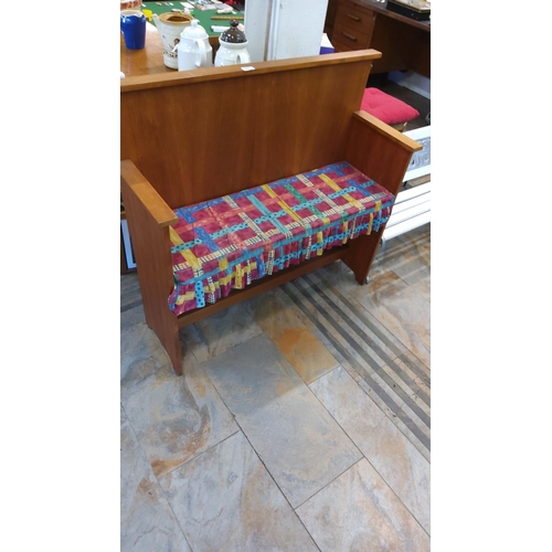 64 - Mid-century wooden bench with colorful fabric seat cover.