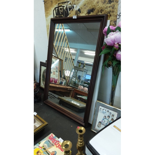 68 - Large wooden-framed wall mirror with a classic mahogany finish