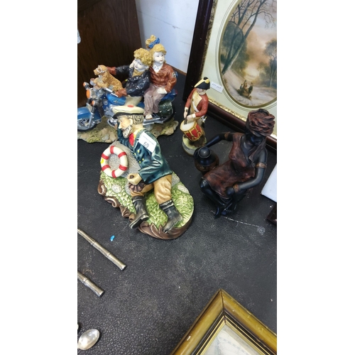 69 - Assorted decorative figurines include a maritime-themed sailor, motorbike couple, and drummer boy. T... 