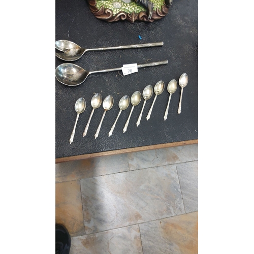 70 - Sterling silver-plated flatware set includes two vintage serving spoons and eight intricately design... 