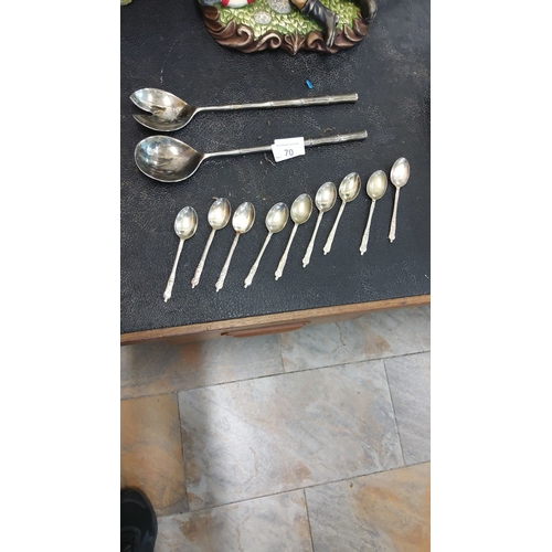 70 - Sterling silver-plated flatware set includes two vintage serving spoons and eight intricately design... 