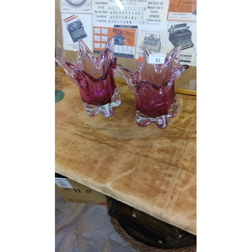 81 - Pair of mid-century cranberry murano  glass vases with folded petal design and clear bases.