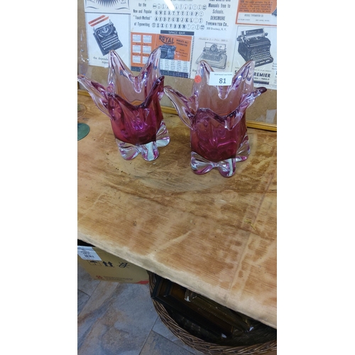 81 - Pair of mid-century cranberry murano  glass vases with folded petal design and clear bases.