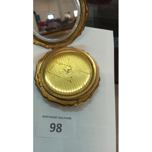 98 - Vintage Stratton gold-tone compact features a mirror, scalloped edges, and an original powder puff. ... 