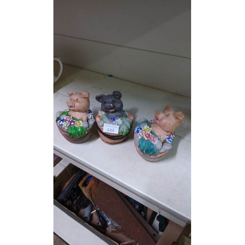 144 - Set of three hand-painted stone pig figurines in flower-adorned tubs. Playful and colorful.