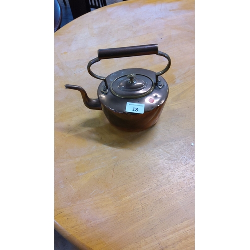 18 - Antique copper kettle with curved spout and hinged handle. This early 20th-century piece has a rich ... 