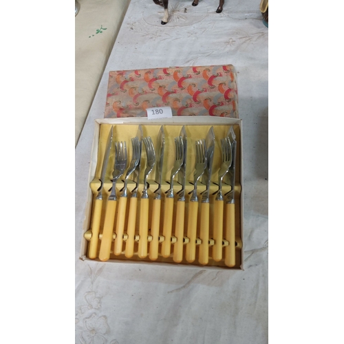 180 - Vintage boxed cutlery set features stainless steel knives and forks with yellow Bakelite handles. El... 