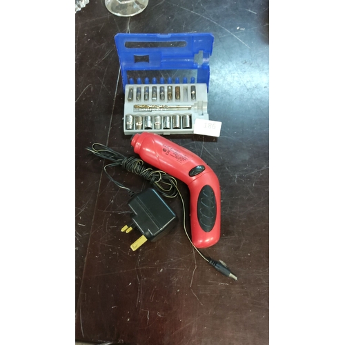 186 - Cordless electric screwdriver comes with a charger and accessory bit set in a blue plastic case.