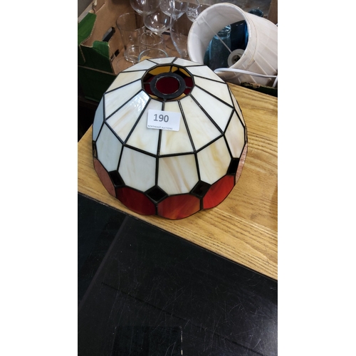 190 - Stained glass lamp shade with geometric design in cream, red, and black tones.