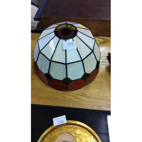 191 - Stained glass lamp shade features a geometric panel design in cream, red, and black tones.