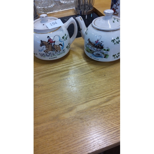 194 - Pair of Irish-themed ceramic teapots feature hand-painted hunting and carriage scenes, accented with... 