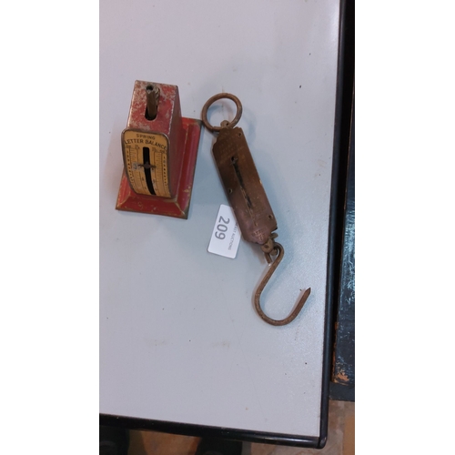 209 - Vintage spring letter balance scale with red-painted metal base and an antique brass hanging scale.