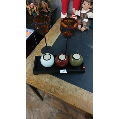 237 - Decorative candle holder set includes two amber glass votive holders with wrought iron accents and t... 