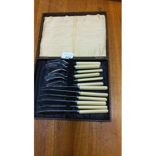 262 - Vintage boxed carving set with bone-colored handles, including forks and knives. Housed in original ... 