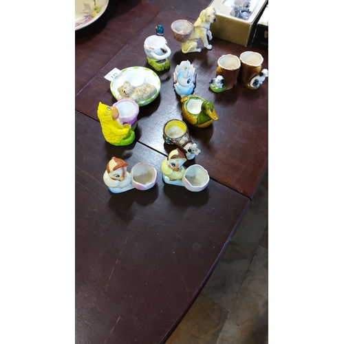 279 - Collection of mid-century ceramic figural egg cups and novelty holders with animal-themed designs. T... 