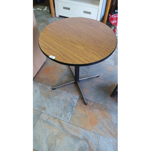 294 - Mid-century modern round café table features a faux wood laminate top and a sturdy metal base.