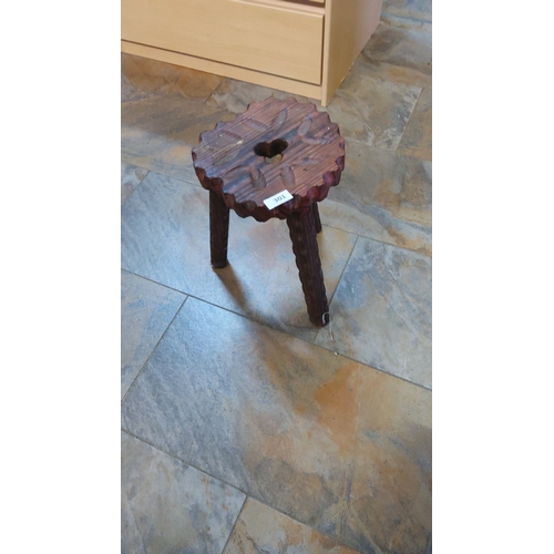 301 - Rustic carved wooden stool with a scalloped edge and decorative floral motif. Features a sturdy thre... 