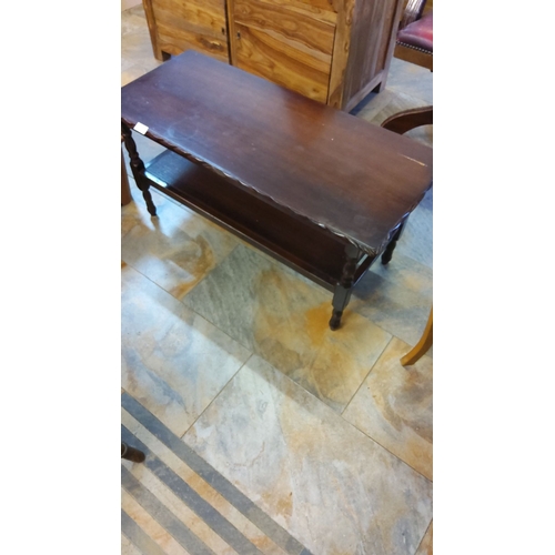 303 - Vintage wooden coffee table features turned legs and a lower shelf, with a dark-stained finish and s... 