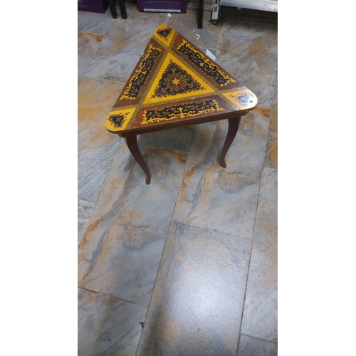 31 - 1950s Italian ornately decorated triangular musical box side table with marquetry inlay design. Feat... 