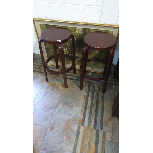 325 - Pair of vintage bentwood bar stools have a dark brown finish. They feature a mid-century design with... 