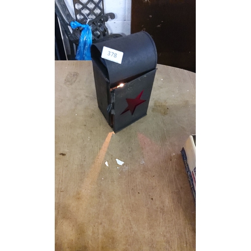 378 - Vintage black metal candle lantern with red star cutout, featuring hinged door and handle.