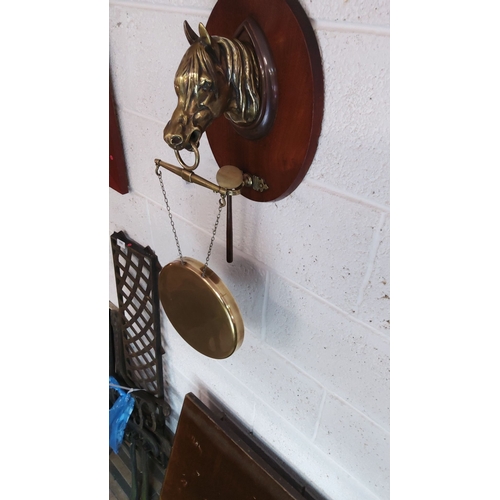 386 - Vintage brass and wood wall-mounted dinner gong features a horse head motif, a brass gong, and a str... 