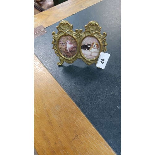 44 - Ornate brass double photo frame with Rococo-style detailing. Features two oval openings. A charming ... 