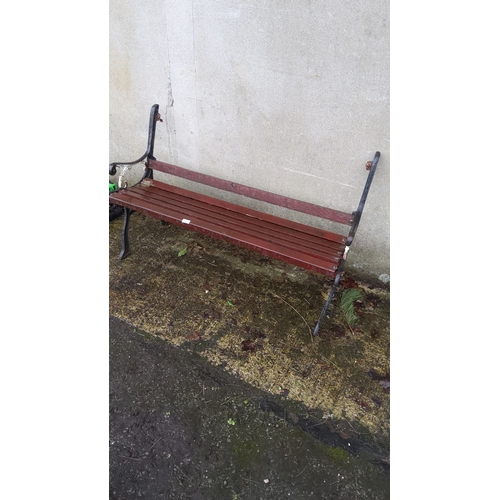 459 - Vintage cast iron and wood garden bench. Classic slatted wooden seat with ornate cast iron frame.