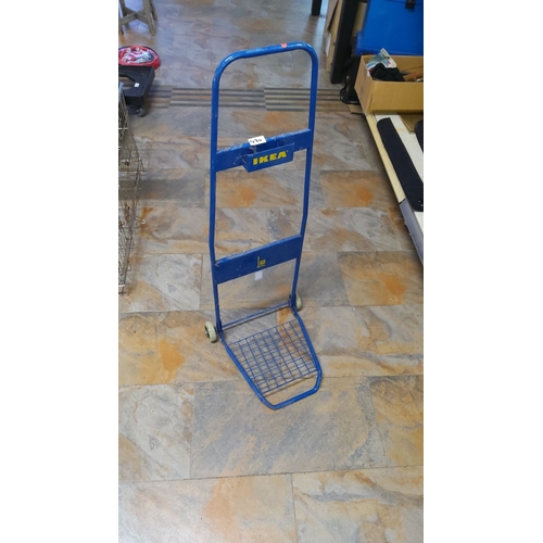 470 - IKEA blue folding hand truck has a sturdy metal frame with two wheels. It features a compact design ... 