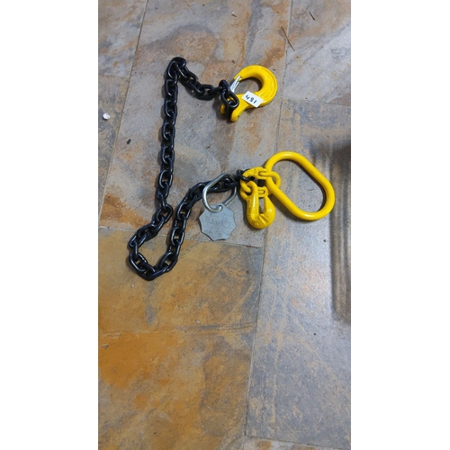 481 - Heavy-duty chain sling with yellow lifting hooks and master link.