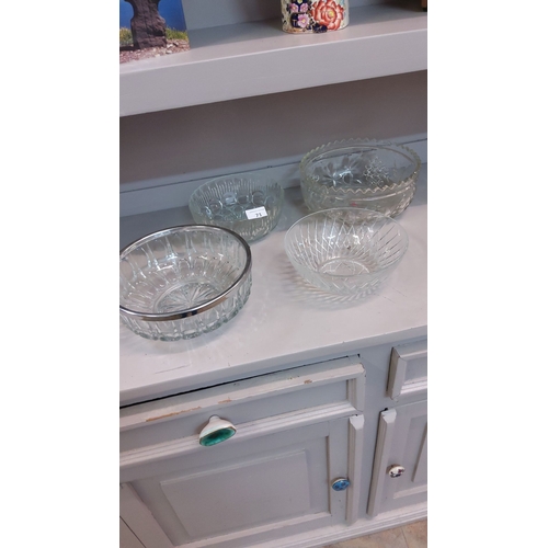 71 - Set of four vintage cut glass bowls, featuring various decorative patterns. Includes one with a silv... 