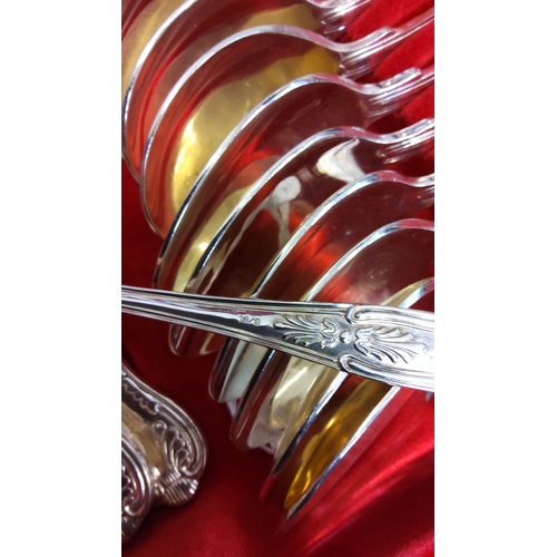 80 - Silver-plated flatware set in a fitted wooden case with ornate handles and gold-toned bowls. Include... 