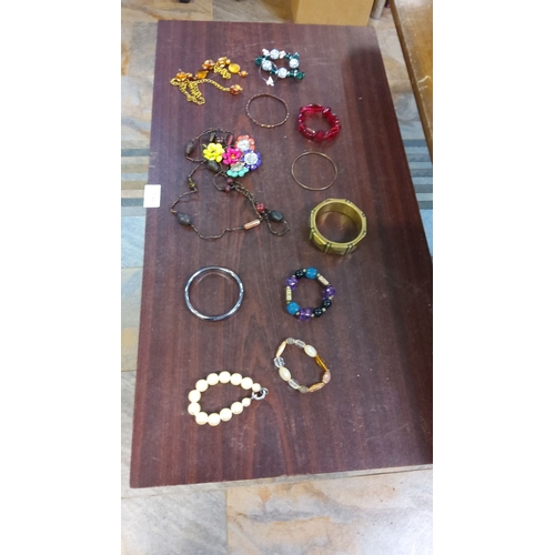 246 - Vintage costume jewelry lot, including beaded necklaces, bangles, and stretch bracelets in mixed mat... 