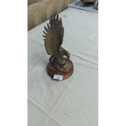 12 - Brass eagle figurine on a wooden base, intricately detailed with outstretched wings.