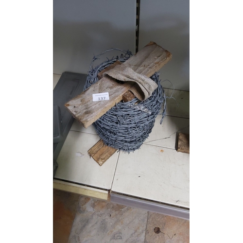 137 - Roll of barbed wire with wooden supports