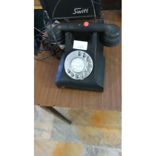 148 - Vintage mid-20th century rotary dial telephone in black Bakelite with a metal dial plate.(sd)