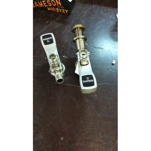 175 - Pair of Guinness beer keg couplers, stainless steel construction with branded handles.