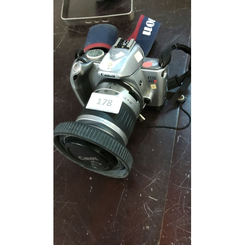 178 - Canon EOS 300 film SLR camera with 28-90mm zoom lens. Includes Canon strap and lens cap.