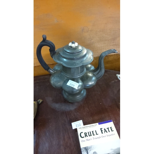 209 - Antique pewter teapot with a bulbous lobed body, curved spout, and black handle. Finial adorned with... 